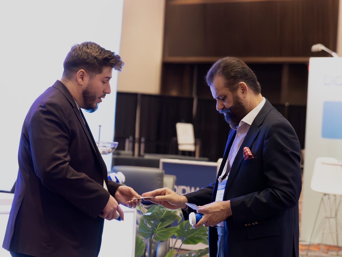 A 1 Touch Communications advisor reviewing options with a client at an industry event